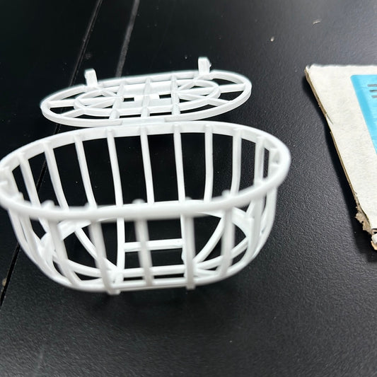 Multi purpose nesting material holder